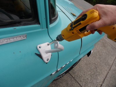 Marked the lower hole from the inside of the door.  Drilled the lower hole from the inside with a long bit then mounted the mirror with the lower hole.  This allowed me to drill the top holes,  don't trust the inside door locator holes.