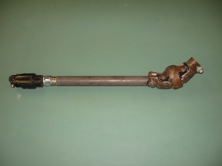 '98 Ford Econoline 150 steering shaft before it fell under the saw. Note the cute little double-Cardan u-joint; stock column angle is a little sharp for a single u-joint, so this looked like a perfect solution. I almost got away with simply clamping the 3/4&quot;-36 spline Ford front u-joint to the 11/16&quot;-36 spline on the Nissan box, but it put the joint in a bind.